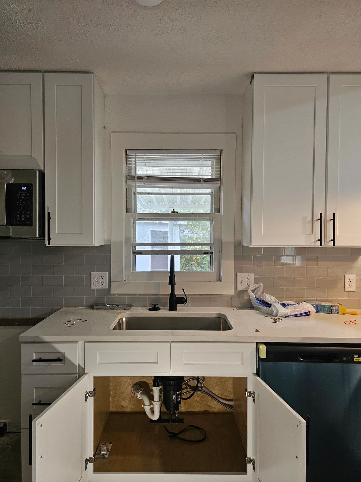 Kitchen sink, disposal, and supply lines after a residential plumbing install